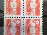 a close up of four stamps with a picture of a man on them