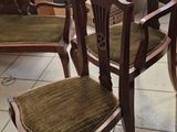many chairs and tables in a room with a lot of windows