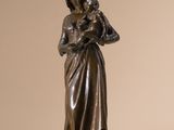 bronze statue of a woman holding a child in her arms