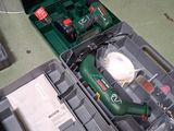 a green box with tools in it sitting on a table