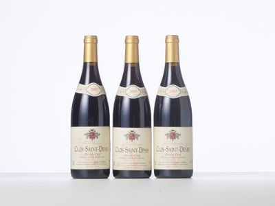 three bottles of wine are lined up on a table