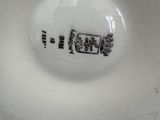 a close up of a white bowl with black writing on it