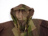 a camouflage jacket with a hood on it on a white surface
