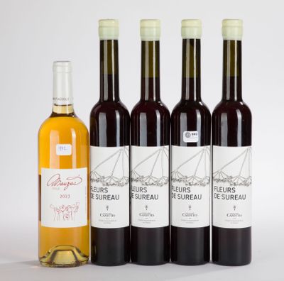 four bottles of wine sitting next to each other on a table