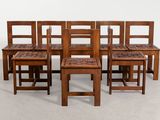 set of six chairs and a table in the shape of a bench