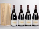 three bottles of wine are lined up in front of a wooden box
