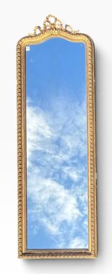 a mirror on the wall with a sky in the background