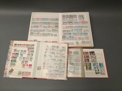 three open books with stamps on them sitting on a table