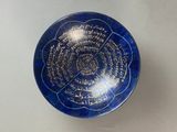 a picture of a blue bowl with writing on it