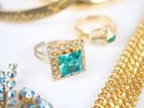 many different types of jewelry displayed on a table
