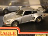 a silver toy car on display in a display case
