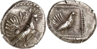 a close up of a coin with a bird on it