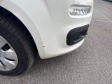a close up of a white car parked in a parking lot