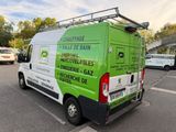 a green van that is parked in a parking lot