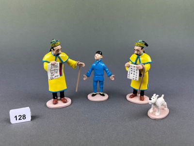 three figurines of a man with a dog and a man with a newspaper
