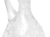 the clear glass pitcher is sitting on a white surface