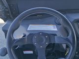 a close up of a steering wheel on a golf cart