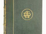 an old green book with a gold logo on it