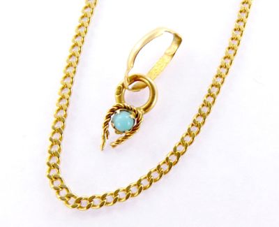 a close up of a gold chain with a turquoise stone on it