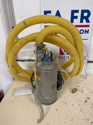 a yellow hose that is connected to a metal pump