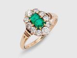 an emerald and diamond cluster ring