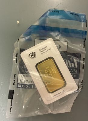 a gold bar in a plastic bag on a table