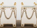 two white and gold vases sitting on top of a table