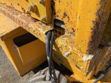 a close up of a yellow dump truck with a black handle