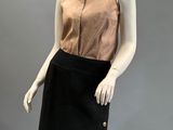 an image of a mannequin wearing a black skirt and a tan top