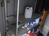 a metal shelf with a hose on it in a room