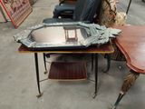 a table with a mirror on top of it and a chair in the background