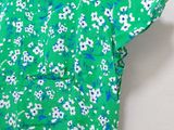 green floral dress with blue and white flowers on it