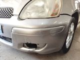 a silver car that is parked in a garage