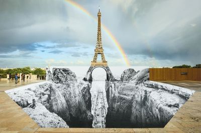 a picture of the eiffel tower with a rainbow in the background