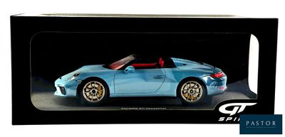 a blue toy car in a black box on a white background