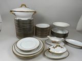 a lot of plates and bowls that are on the table