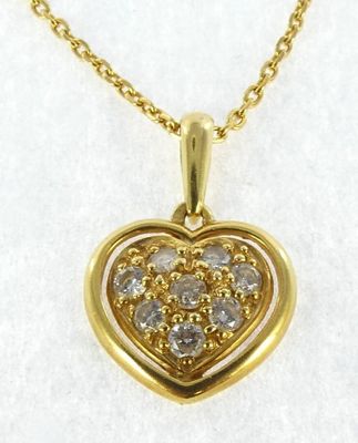 a yellow gold heart shaped pendant with diamonds on a chain