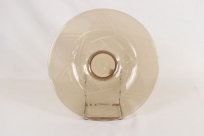 a glass plate with a ring on it on a white surface
