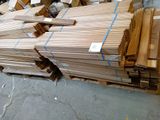 a large stack of wooden planks stacked on top of each other