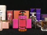 a lot of different perfume bottles on a table