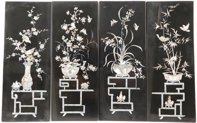 four panels of black and white flowers and vases on stands