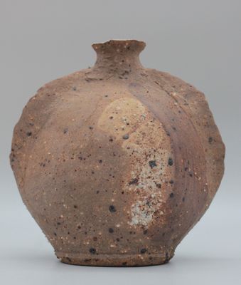 a brown vase that is sitting on a table