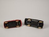two miniature cars that are sitting side by side