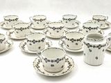 a lot of cups and saucers sitting on a table
