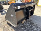 an image of a black skid steer on a gravel lot