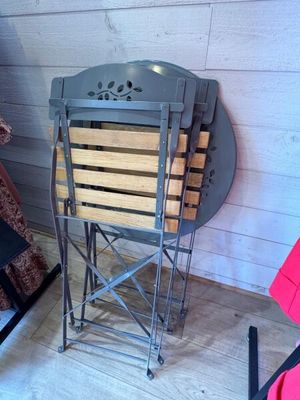 a small folding table in a room with a teddy bear