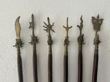 four antique wooden and brass handled knives with birds on them