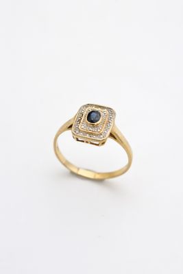 an image of a gold ring with a black diamond