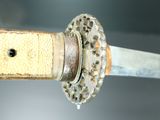 a close up of a sword with a metal handle