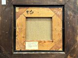 an old picture frame with a small piece of wood in it